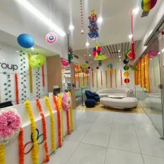 We transform everyday office spaces for festive occasions. Here, a corporate reception area is decorated for Diwali using traditional marigold garlands, colorful paper lanterns, and hanging crafts to create a warm and celebratory atmosphere for employees and visitors.