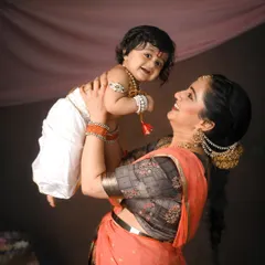 A joyful, uplifting moment between mother and child. The dynamic pose and genuine smiles make this a standout portrait from the festive series.