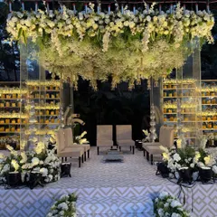 This floral wonderland captures the essence of love in full bloom. I designed this mandap with a canopy of cascading white blossoms and a candlelit backdrop to create a breathtakingly romantic atmosphere.