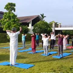 Another angle of our outdoor yoga class, showing the instructor guiding the participants. We ensure personalized attention even in group settings.