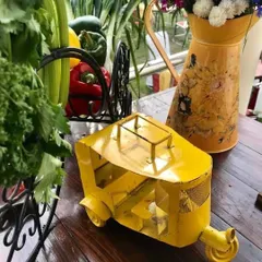 A quirky, yellow auto-rickshaw miniature used as a decor piece. We love incorporating fun and unique objects that add character and a talking point to our event styling.