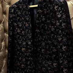 This is a custom party coat made from a luxurious black floral velvet fabric. It's perfect for a sangeet, cocktail party, or any evening event where you want to look elegant and stylish.