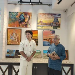 Curator Sarthak and art connoisseur Sridhar Comaravalli admire the collection of spiritual and landscape paintings at the "Vernissage" show.