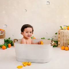A bright, happy smile from the tub. These baby bath photoshoots are always full of giggles and fun.