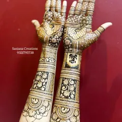 This full-arm bridal design combines traditional peacock motifs with modern floral patterns and a special Ganesh-ji figure for blessings.