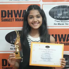 The pure happiness of achievement. This student's bright smile says it all as she holds her well-deserved trophy and certificate.