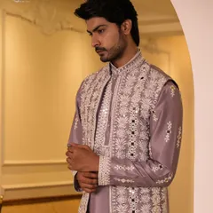 A close-up of the lilac Indo-Western jacket, showcasing the intricate mirror and thread work. The craftsmanship adds a layer of luxury to this contemporary design.