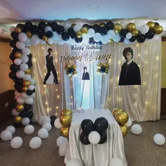 A stylish black, white, and gold themed birthday party for twins Vihaan and Avni. This setup features a full balloon arch and a custom backdrop, creating an elegant and fun atmosphere for the celebration.