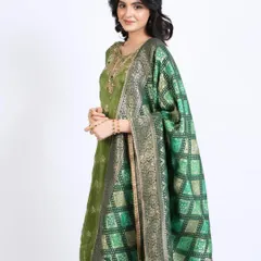 The full ethnic look, showing how the hair and makeup complement the rich green and gold attire.