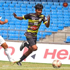 A player from my academy on the move during a Football Delhi B Division league match, played in a professional stadium setting.