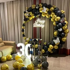 Celebrate a milestone 30th birthday in style with this chic black and gold theme. The decoration includes a full balloon ring, large light-up numbers, and a photo display stand, creating a sophisticated and fun party atmosphere.