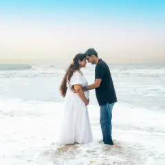A quiet, intimate moment for expecting parents on a serene Mumbai beach. The soft light and gentle waves create a timeless and romantic portrait that focuses entirely on their connection before the baby arrives.