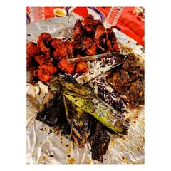 A true non-veg delight. This platter combines spicy chicken starters, fish wrapped and cooked in banana leaves for a unique flavour, and other fried delicacies, all served on a bed of fresh cabbage.