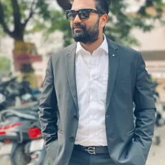 Dressed for court, standing outside near a parking area. In the legal profession, as in life, one needs an attitude of survival and the determination to see things through.