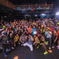 The whole family. A group photo with all the presenters and participants after a massive Zumba masterclass. These events are about building a strong, happy, and healthy community.