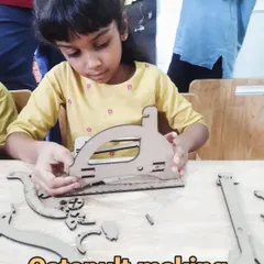 A young girl begins assembling a catapult, one of our many DIY engineering kits that teach physics principles.