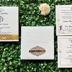 A beautiful Christian wedding invitation in white and gold. The design is clean and elegant, featuring a cross and the couple's monogram.