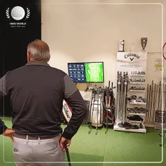 The moment of truth. A client reviews his performance data on the monitor, seeing exactly where his shots are landing and the metrics behind each swing.