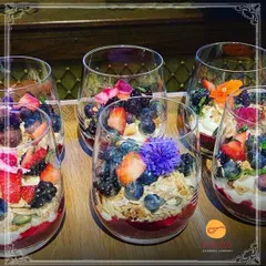 Our healthy breakfast or snack option: berry and granola parfaits. Layers of yogurt, fruit compote, and crunchy granola are served in individual glasses for a convenient and nutritious treat.