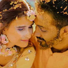 A close-up portrait from a Haldi ceremony at Amar Mahal, Orchha. This shot captures the raw emotion and tradition of the moment, with turmeric paste and flower petals adorning the couple.