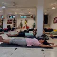After an intense practice, students rest together in Savasana. There is a unique power in sharing silence and stillness as a group.