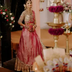 The full view of this gorgeous half saree outfit. The combination of the rich pink skirt, contrasting dupatta, and intricately embroidered blouse creates a stunning traditional look.
