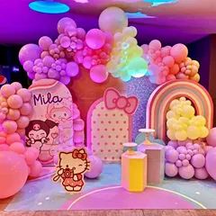 A dreamy Hello Kitty themed birthday party for baby Mila. This setup uses a soft pastel color palette, with adorable character cutouts, a rainbow prop, and extensive balloon decorations to create a whimsical and sweet wonderland.