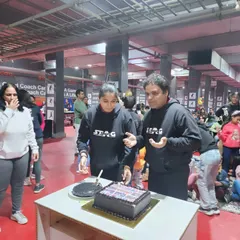 Cutting the cake to celebrate another year of success, growth, and community at Alight Table Tennis Excellence Centre.