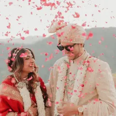 A joyous moment captured. The groom wears our custom-designed sherwani, paired with a matching safa and sunglasses for a cool, modern twist on a classic wedding look.