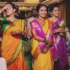 Stepping into forever. A candid shot of the bride's entrance, surrounded by her loved ones.
