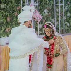 The Varmala ceremony, a pivotal moment in any Indian wedding. I position myself to capture the expressions of both the bride and groom as they exchange garlands.