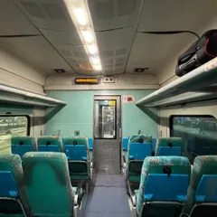 The interior of an empty coach on the double-decker train, showing the seating arrangement on the upper level.