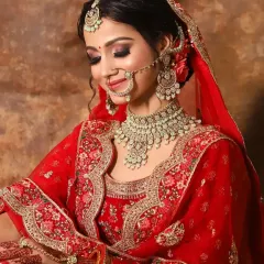 A candid moment of a happy bride. This look features coppery-gold eyeshadow and a soft red lip, a beautiful combination for traditional wear.