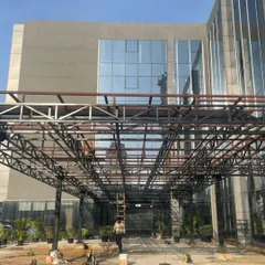 Work in progress at Heritage Xperiential School. This image shows the structural framework of the entrance canopy, offering a glimpse of the building's skeleton before the final layers are applied.