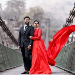A classic pre-wedding shot on a bridge, with her long red gown flowing in the wind. This is a perfect example of the dramatic, "filmy" style I love to create.