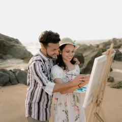 A close-up of the couple collaborating on their artwork. It's a beautiful metaphor for building a life together.