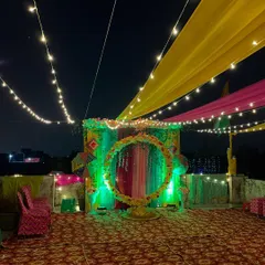 The main backdrop for the Mehndi ceremony, beautifully lit with green lights.