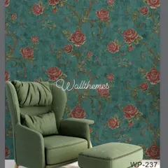 A bold floral wallpaper with red roses on a deep teal background, shown in a mockup with a modern green armchair.