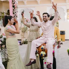 It's not just about the outfits, it's about the vibe. Here's groom Shivam, looking effortlessly stylish and having the time of his life at his Welcome Lunch in a custom pastel embroidered jacket and pants.