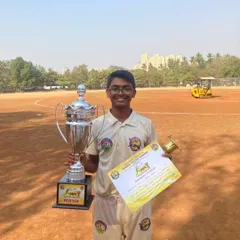 One of our star players from the U-17 MPL winning team, posing with the championship trophy and his winner's certificate.