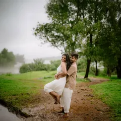 A playful lift in the rain-soaked earth. These are the unscripted, joyful moments that make a pre-wedding shoot so special, capturing pure, unfiltered happiness.