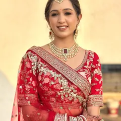 A beautiful portrait of Twinkle in her red bridal lehenga. The makeup is radiant and glowing, exactly as she wanted, making her look and feel like a princess.