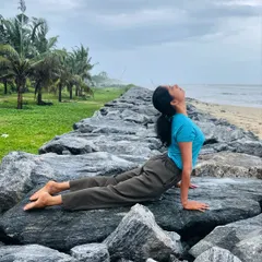 Urdhva Mukha Svanasana, or Upward-Facing Dog, on the coastal rocks. This backbend is a fantastic chest opener, and practicing by the sea allows you to fill your lungs with fresh, clean air.