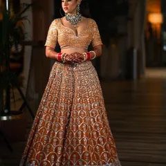 A full-length portrait of the bride in her dazzling Manish Malhotra lehenga, showcasing the stunning craftsmanship of her wedding day attire.