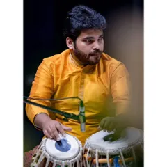 On stage, lost in the rhythm of the tabla during the Malhar Festival. This is the culmination of countless hours of sadhana, where the music flows and connects with the audience.