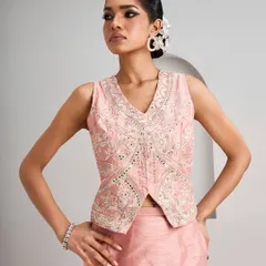 This embroidered vest and skirt set offers a modern take on traditional wear. The detailed craftsmanship of the top pairs beautifully with the simple elegance of the skirt, creating a look that transitions seamlessly from a daytime ceremony to an evening after-party.