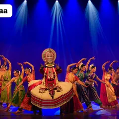 My troupe, Trikayaa Dance Foundation, performing in 'Colours of India'. The stage is lit to create a dramatic atmosphere, highlighting a central Kathakali artist surrounded by a vibrant ensemble.