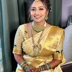 The golden girl. This South Indian bride is absolutely radiant in her golden Kanjeevaram saree, with makeup that enhances her glow and complements her exquisite temple jewelry.