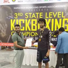 One of our students receiving his certificate and medal at the WAKO Karnataka championship. This is what dedication and consistent training can achieve.