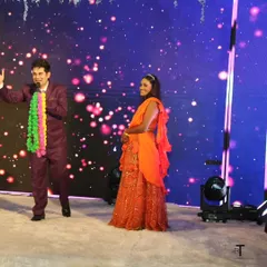 On stage during a sangeet, interacting with a family member. My goal is to make everyone feel like they are a part of the show, not just spectators.